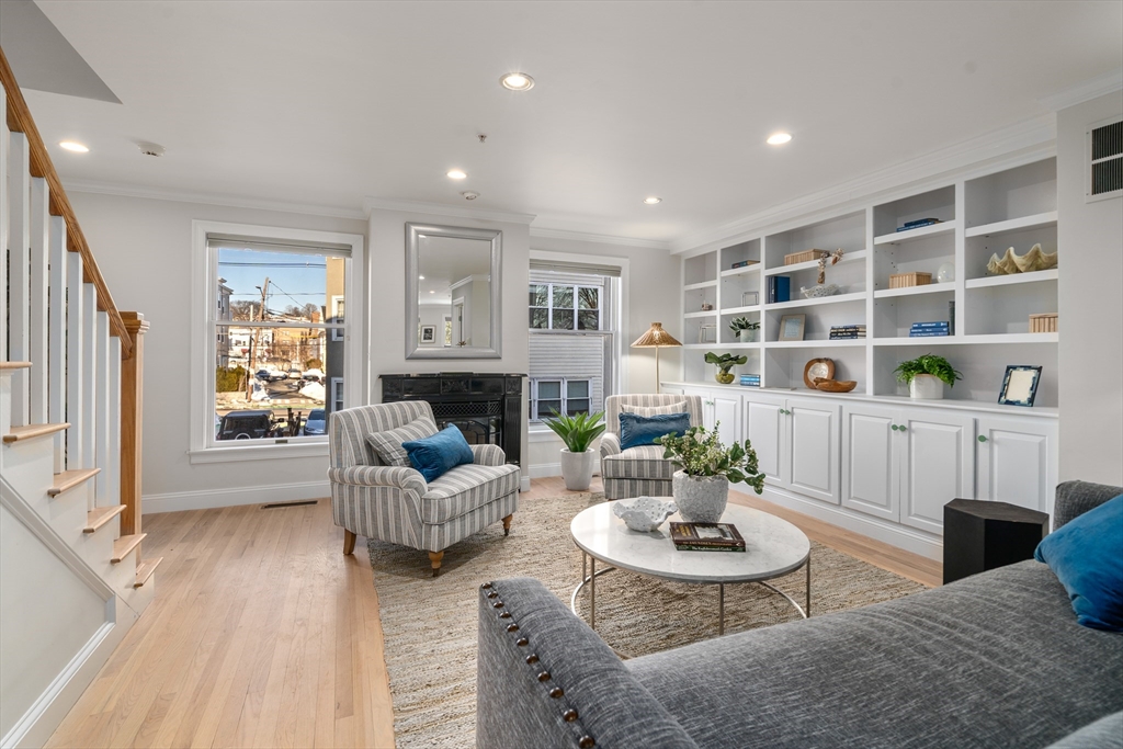 334 Beacon Street, Unit B Somerville, MA 02143 - Photo 2 of 23 a living room with furniture and a fireplace