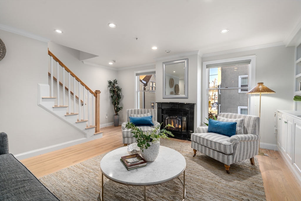 334 Beacon Street, Unit B Somerville, MA 02143 - Photo 3 of 23 a living room with furniture and a fireplace