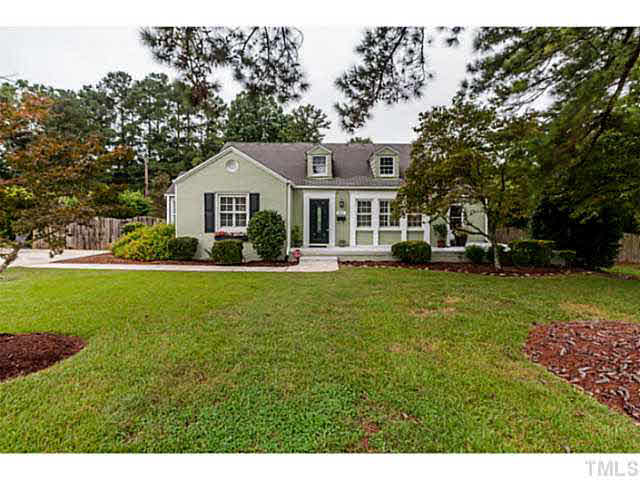 111 North King Charles Road Raleigh, NC 27610 - Photo 1 of 25 a front view of a house with a garden and trees