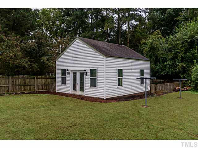 111 North King Charles Road Raleigh, NC 27610 - Photo 21 of 25 a white house with a small yard and large trees