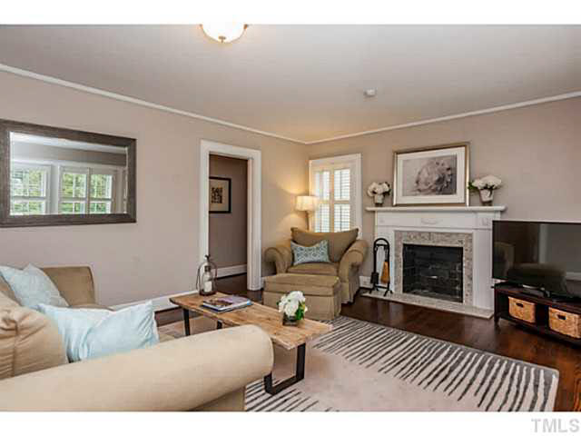 111 North King Charles Road Raleigh, NC 27610 - Photo 3 of 25 a living room with furniture a fireplace and a flat screen tv
