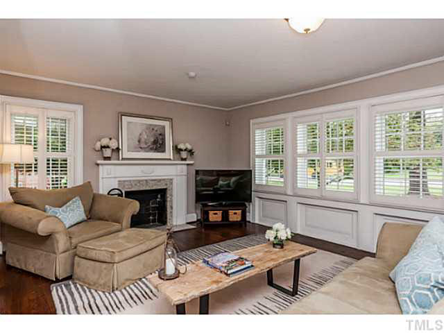 111 North King Charles Road Raleigh, NC 27610 - Photo 8 of 25 a living room with furniture and a fireplace