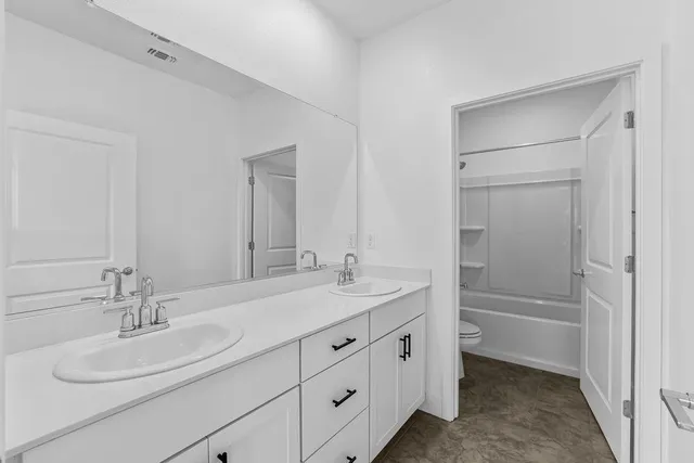 a bathroom with a double vanity sink mirror and double