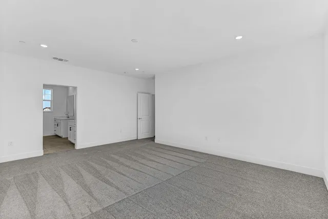 a view of an empty room with many windows