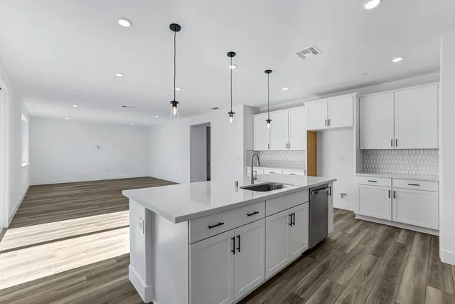 a kitchen with a sink stove and cabinets
