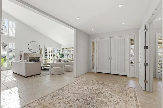 a living room with furniture and a large mirror
