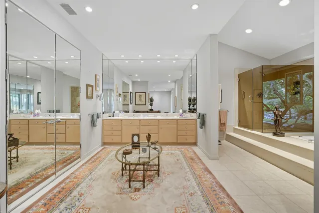 a large white kitchen with a large window