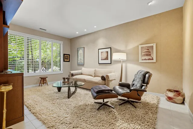 a living room with furniture rug and a window