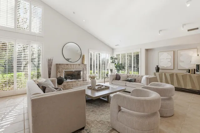 a kitchen with a dining table chairs and white appliances