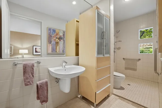 a bathroom with a toilet sink and mirror