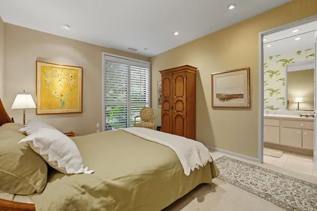 a bedroom with a bed and a refrigerator