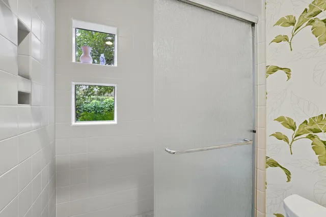 a bathroom with a toilet and a shower