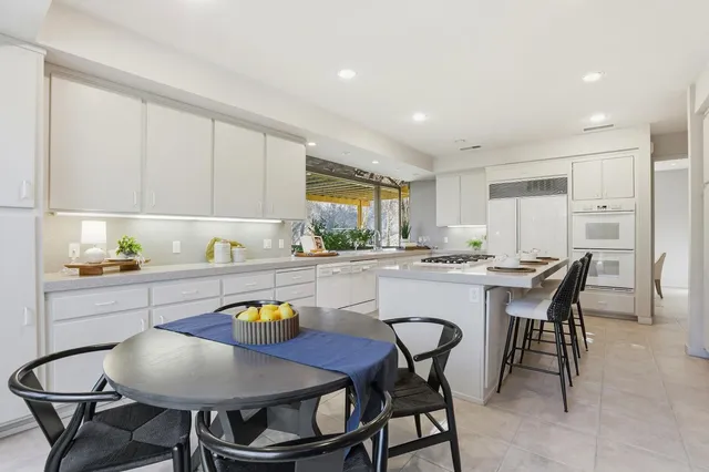 a bathroom with a tub and a large window