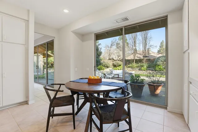 a view of porch with a table and chairs