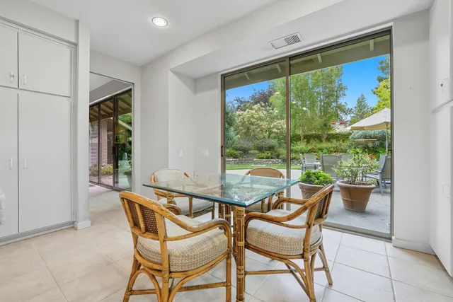 a view of a room with a table and chairs