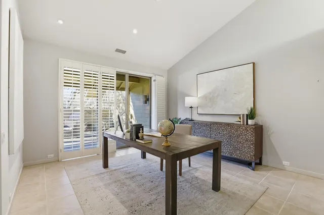 a view of a patio with a dining table and chairs with wooden fence