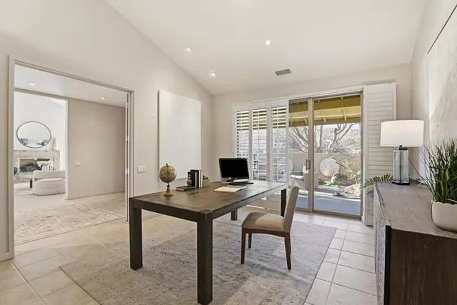 a view of a backyard with plants and large trees