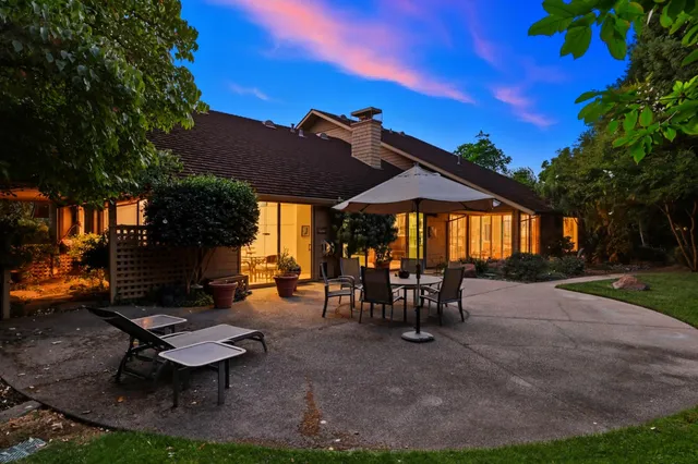 a front view of a house with outdoor seating