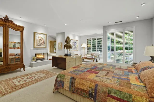 a spacious bedroom with a large bed and a dresser