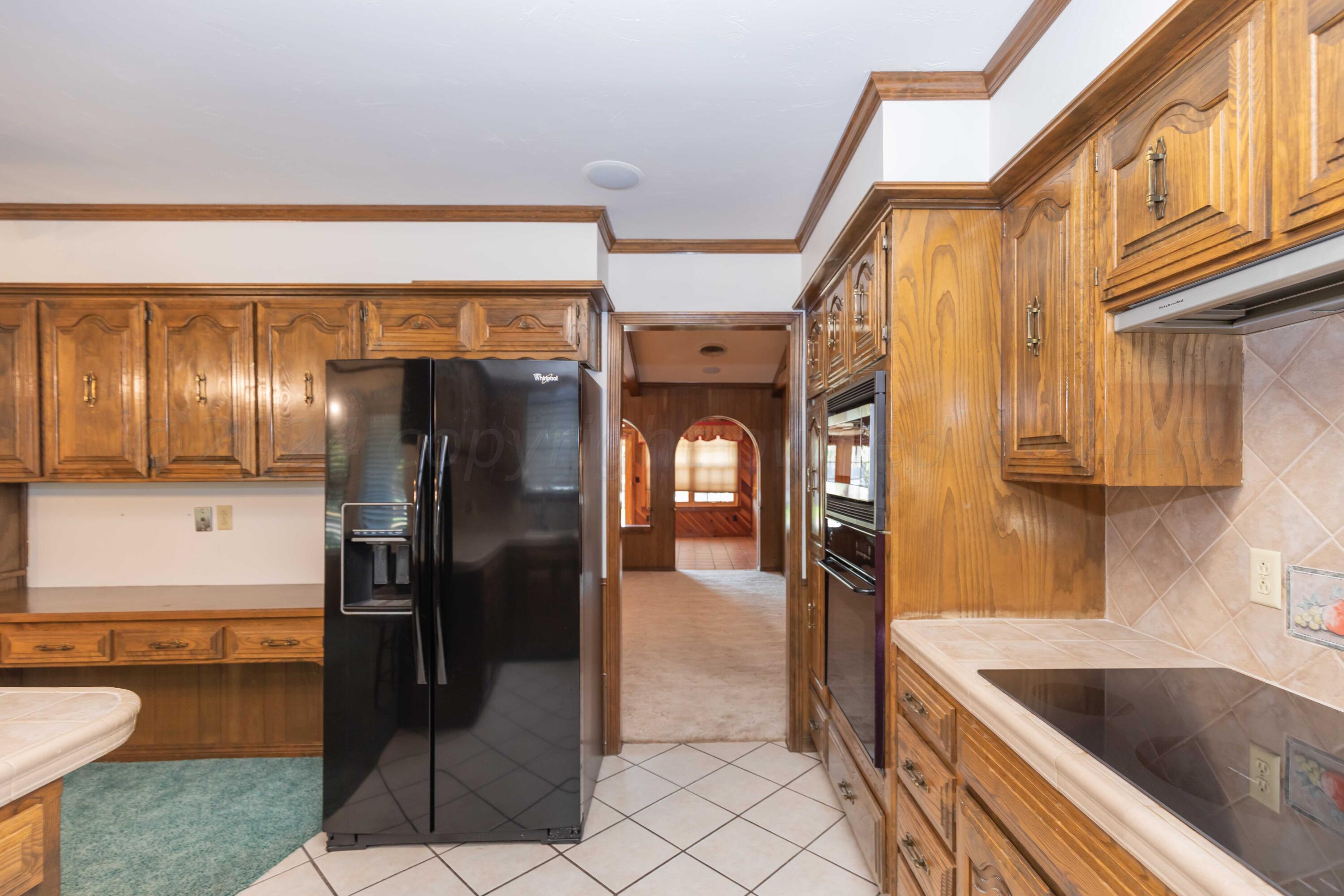 5809 Stone Drive Amarillo, TX 79109 - Photo 12 of 47 a kitchen with stainless steel appliances granite countertop a refrigerator a oven and a sink