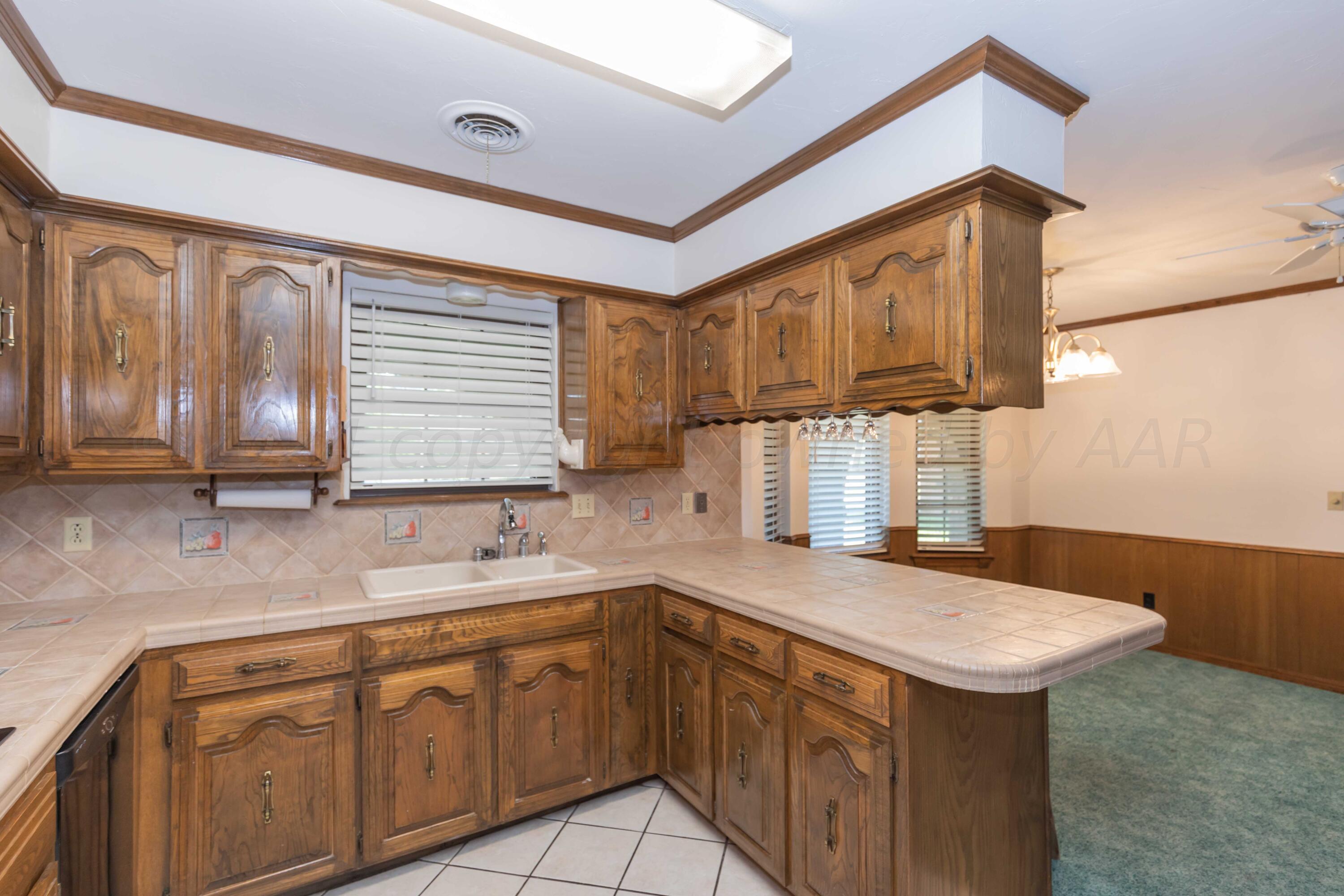 5809 Stone Drive Amarillo, TX 79109 - Photo 14 of 47 a kitchen that has a sink and a stove in it