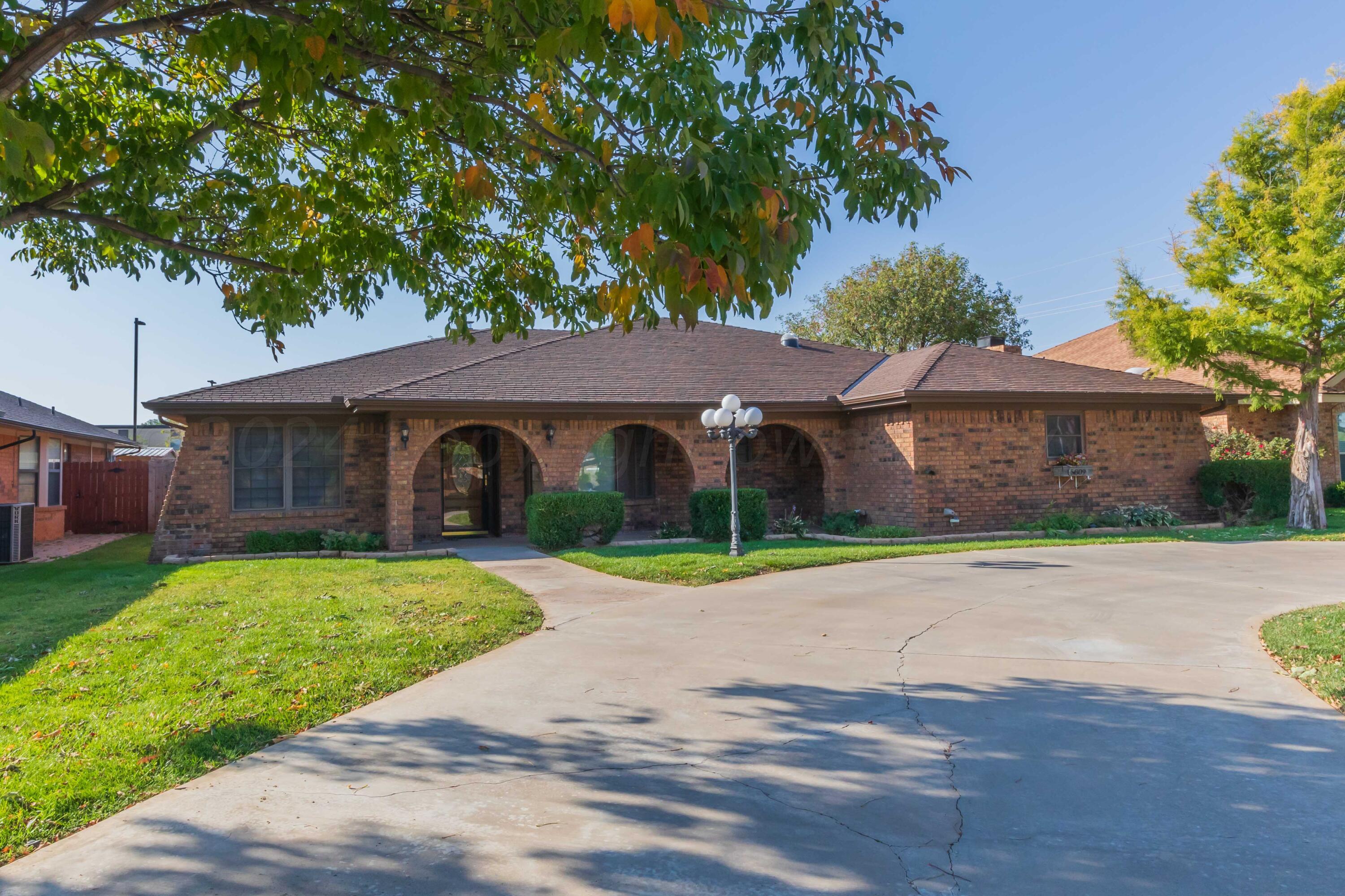 5809 Stone Drive Amarillo, TX 79109 - Photo 2 of 47 a front view of a house with a yard and garage