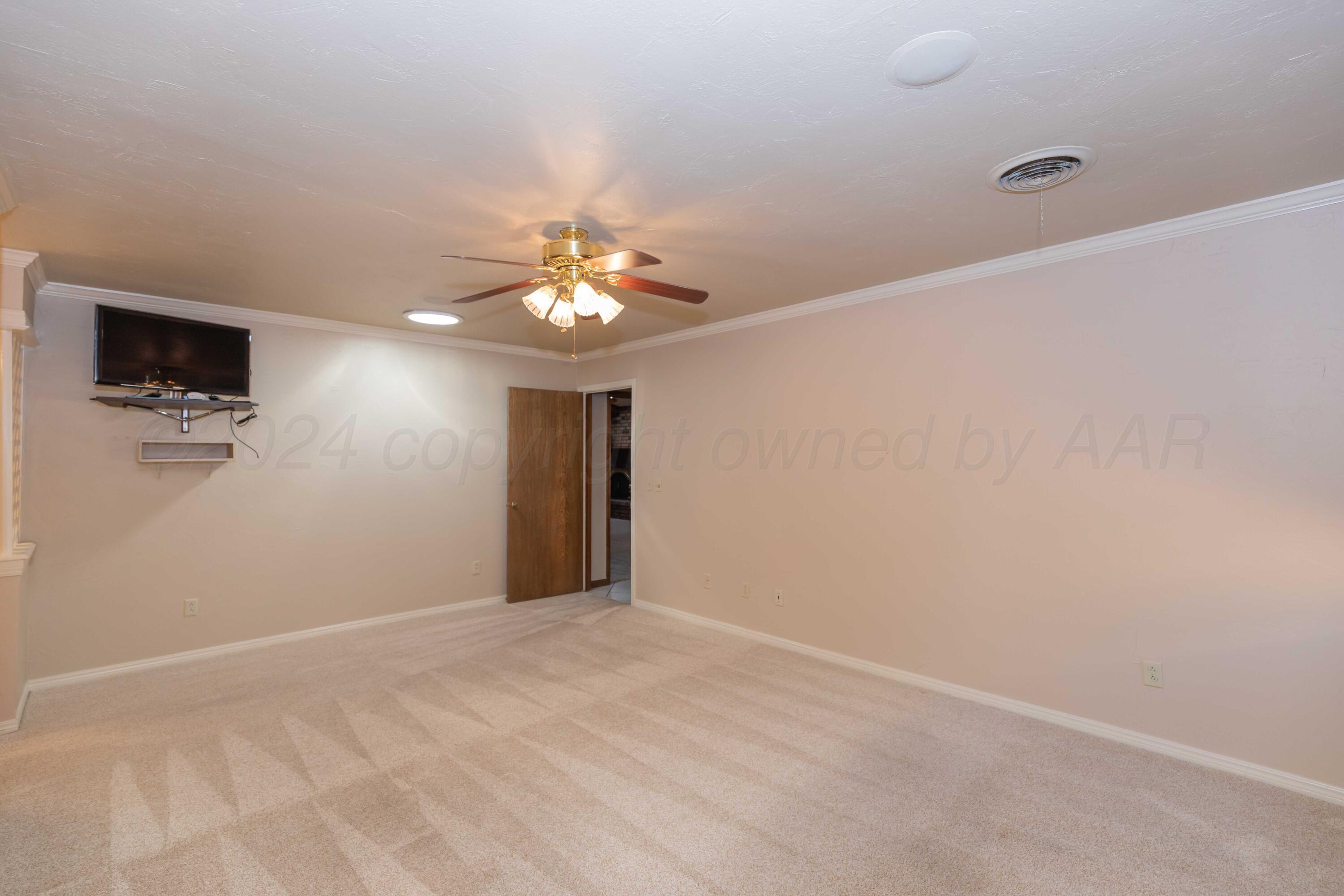 5809 Stone Drive Amarillo, TX 79109 - Photo 23 of 47 a view of an empty room with a chandelier fan