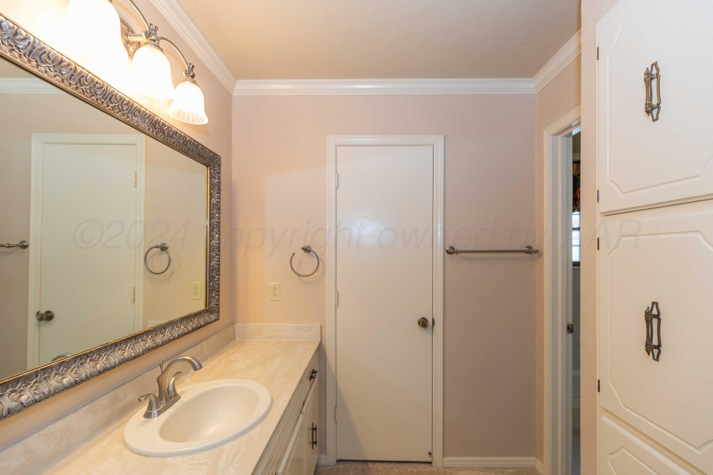 5809 Stone Drive Amarillo, TX 79109 - Photo 25 of 47 a bathroom with a granite countertop sink toilet and shower