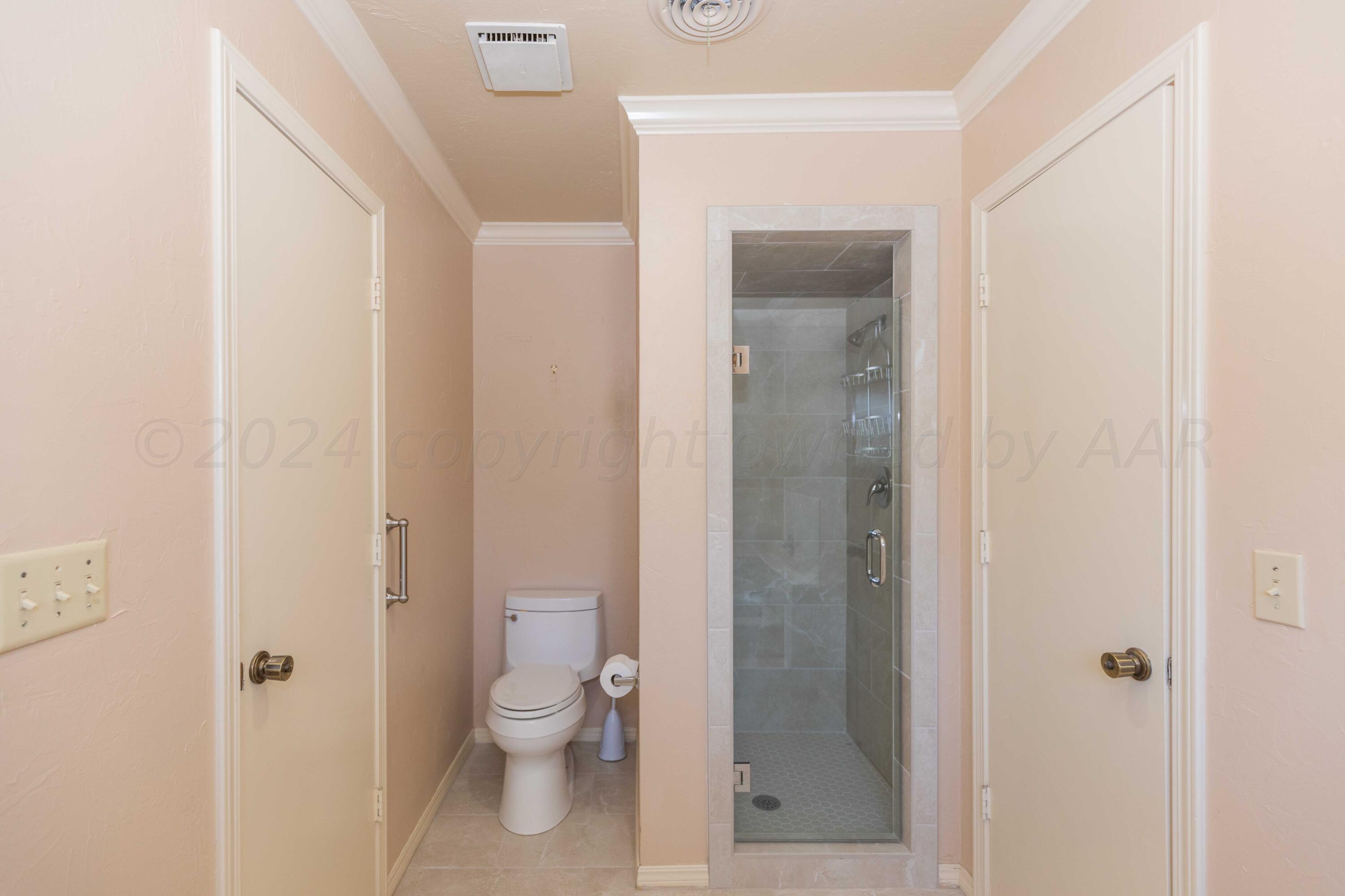 5809 Stone Drive Amarillo, TX 79109 - Photo 26 of 47 a bathroom with a granite countertop toilet and a shower