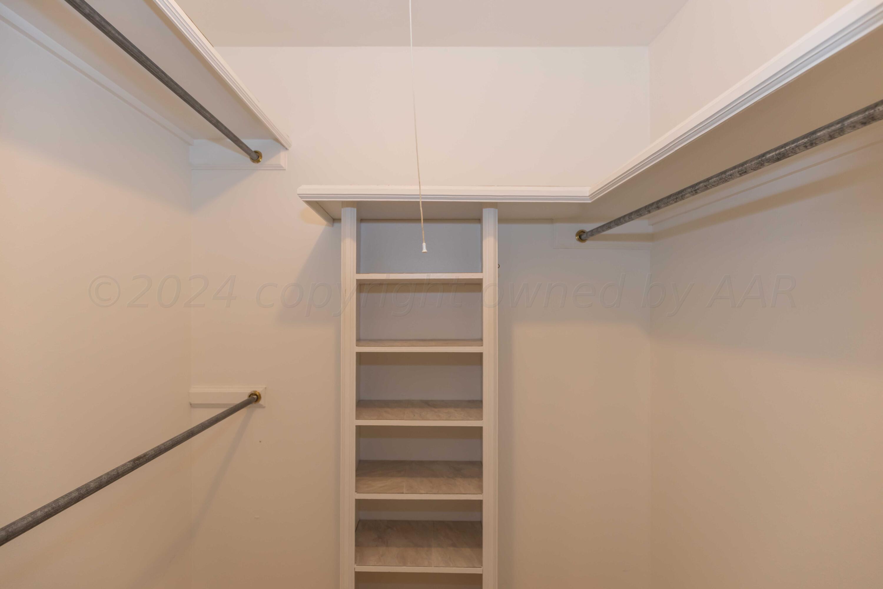5809 Stone Drive Amarillo, TX 79109 - Photo 29 of 47 a view of walk in closet with empty racks