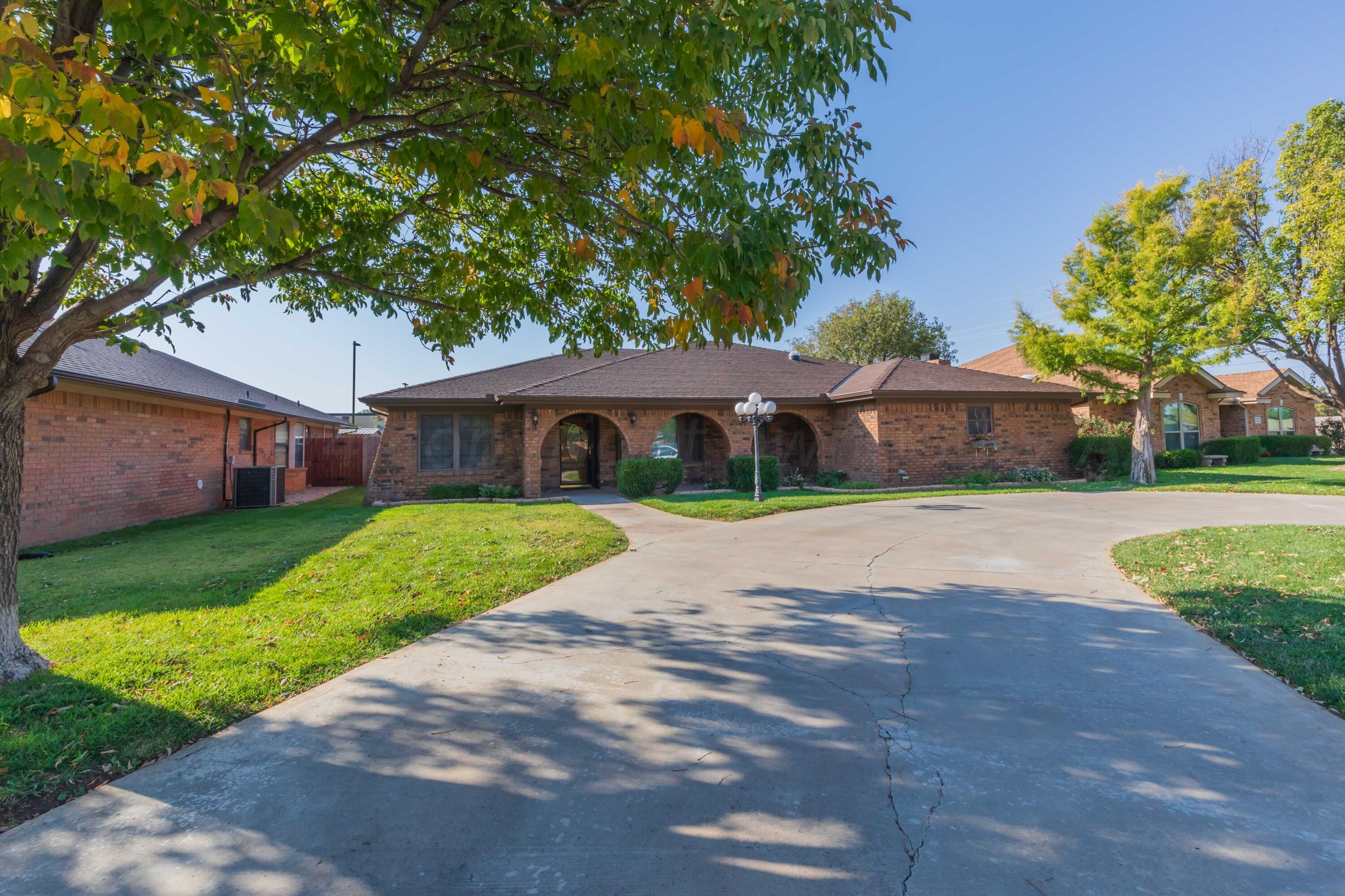 5809 Stone Drive Amarillo, TX 79109 - Photo 3 of 47 a front view of a house with a garden and yard