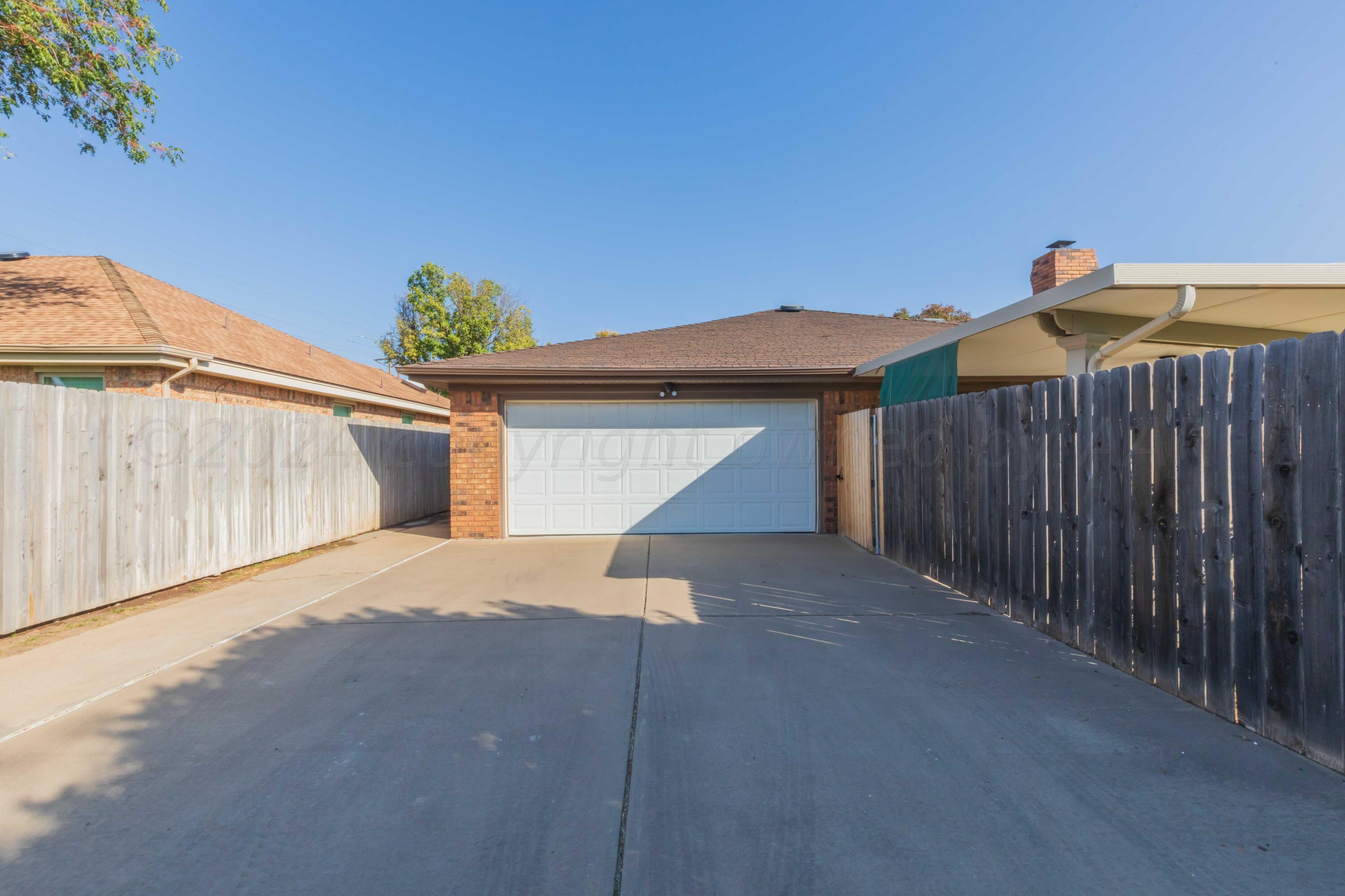 5809 Stone Drive Amarillo, TX 79109 - Photo 41 of 47 a side view of a house with a garage