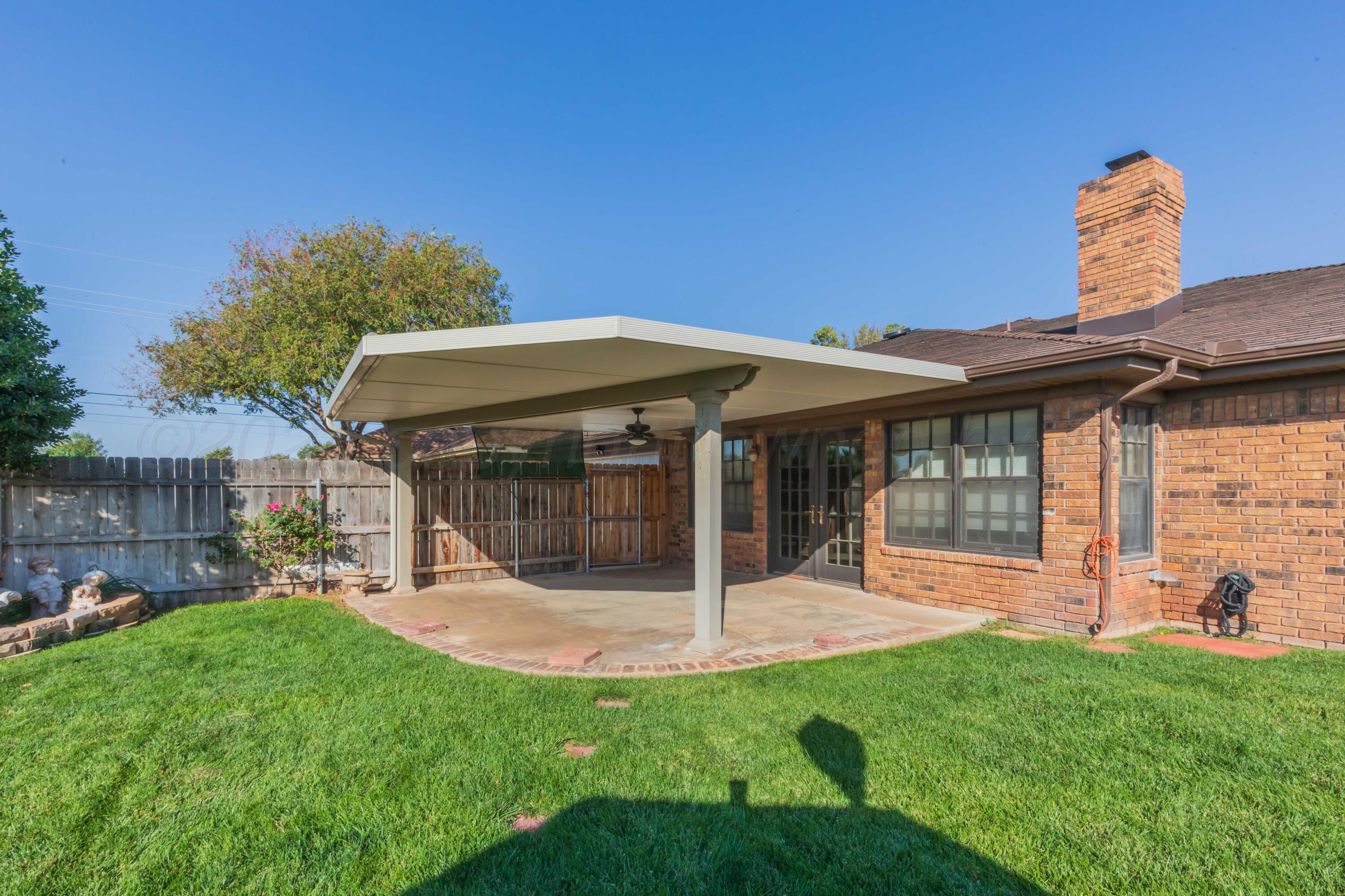 5809 Stone Drive Amarillo, TX 79109 - Photo 43 of 47 a view of a house with a backyard potted plants and a large tree