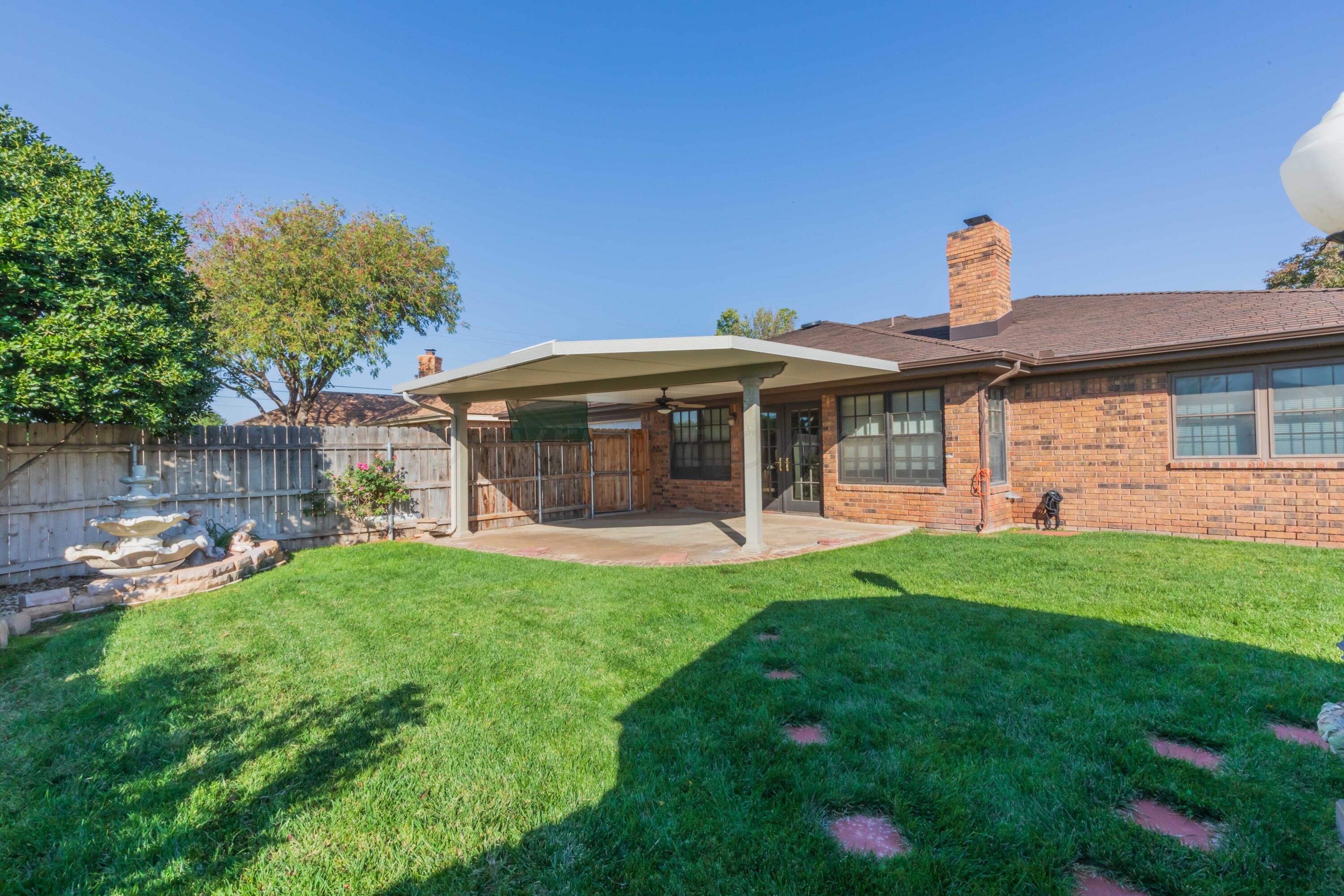 5809 Stone Drive Amarillo, TX 79109 - Photo 45 of 47 a front view of a house with a garden and patio