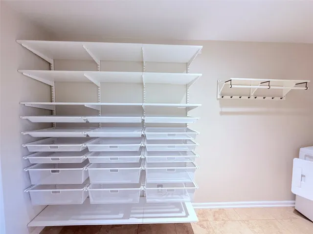 an empty room with windows and ceiling fan