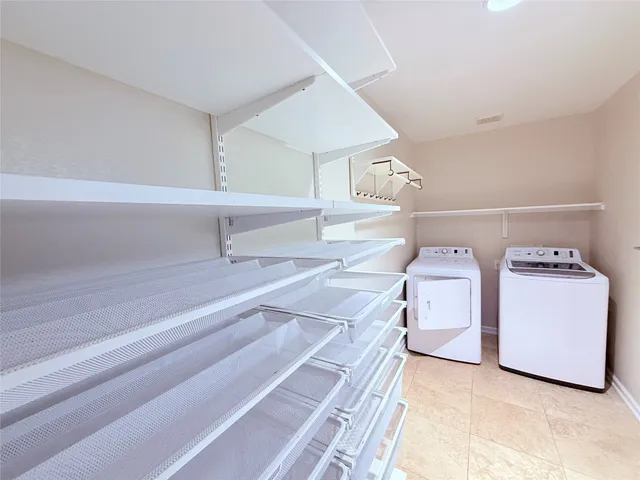 a bathroom with a large mirror a bathtub and a shower