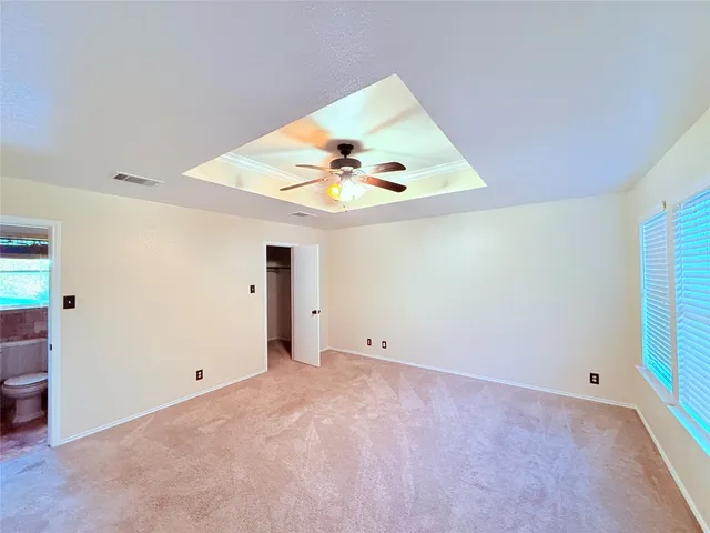 a bathroom with a toilet sink vanity and mirror
