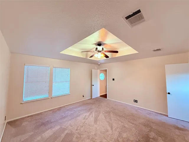 an empty room with closet and windows