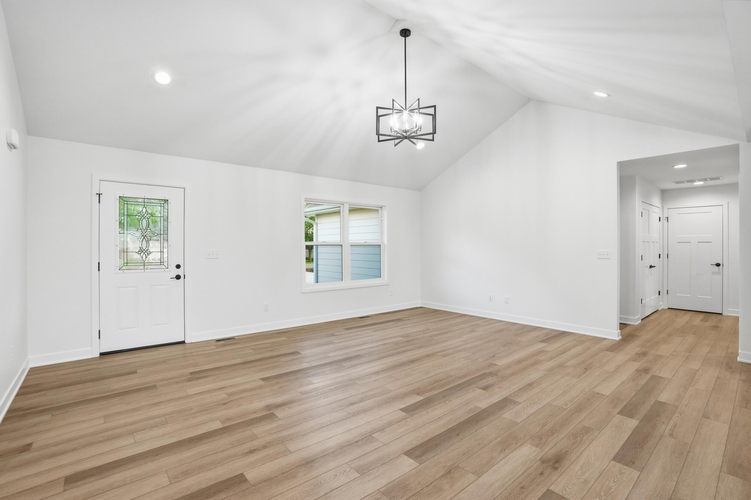 508 West Beaver Street Morocco, IN 47963 - Photo 18 of 33 an empty room with wooden floor front door and windows