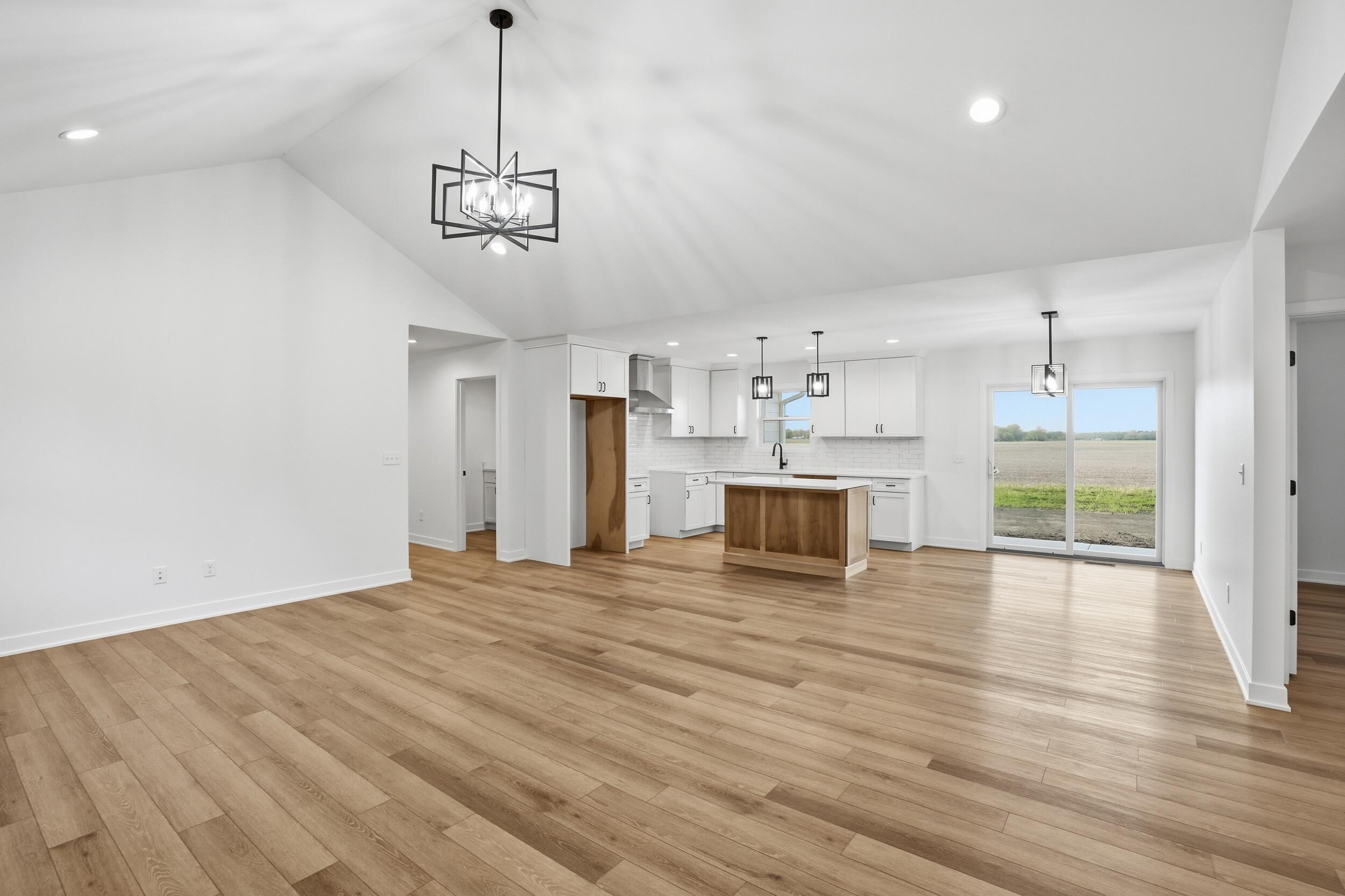 508 West Beaver Street Morocco, IN 47963 - Photo 21 of 33 a view of empty room with wooden floor and kitchen view