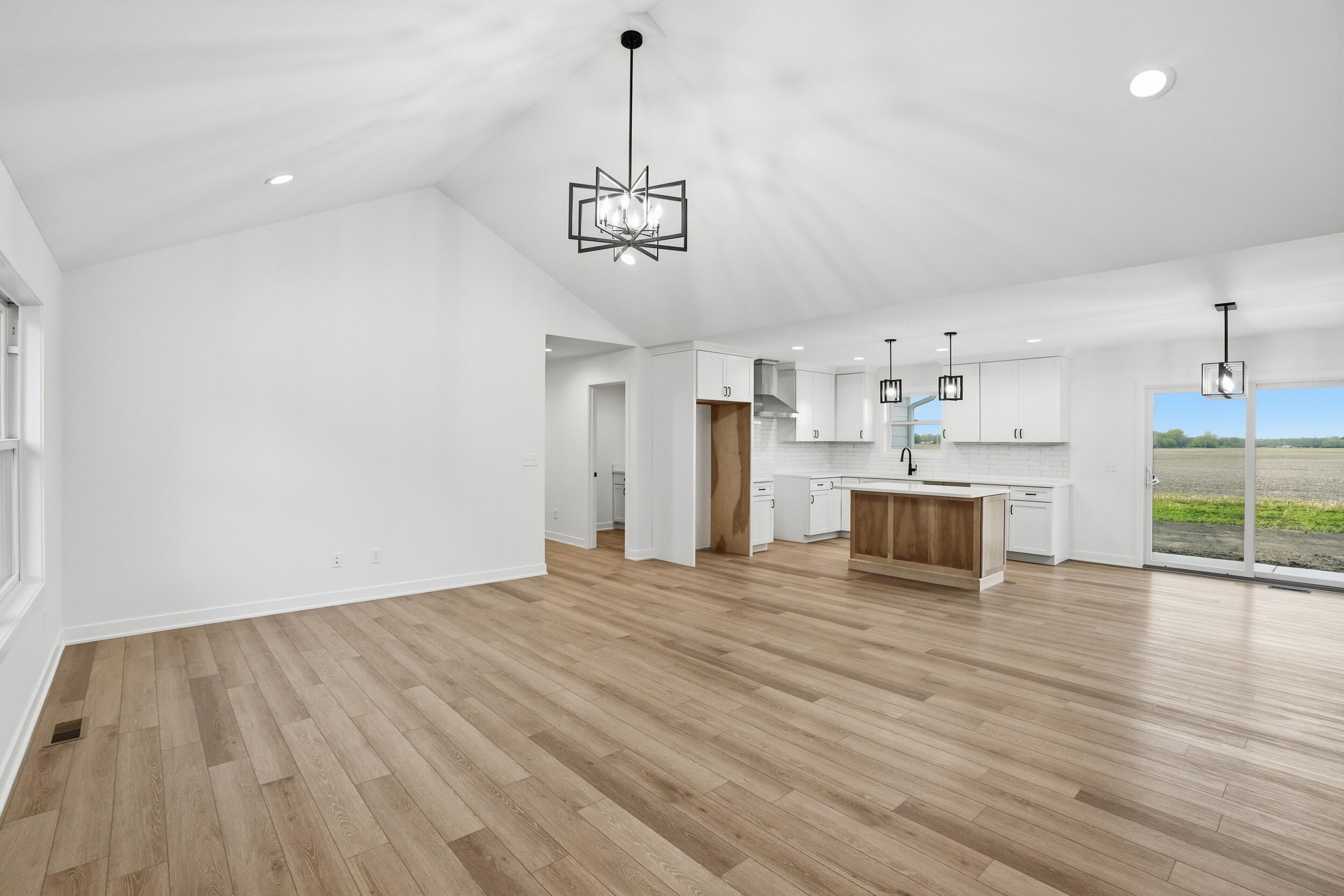 508 West Beaver Street Morocco, IN 47963 - Photo 22 of 33 a view of empty room with wooden floor and kitchen view