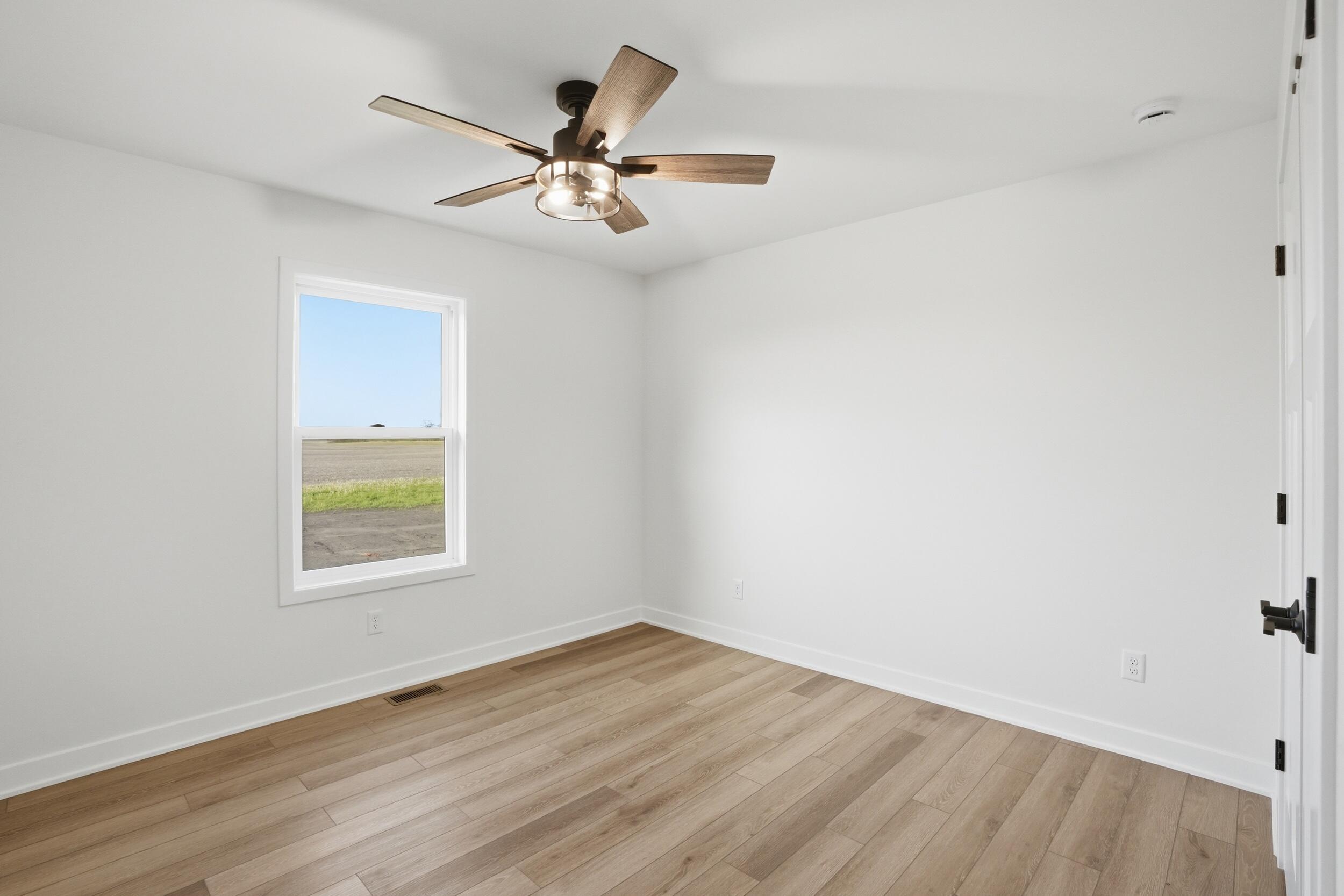 508 West Beaver Street Morocco, IN 47963 - Photo 29 of 33 an empty room with wooden floor fan and windows