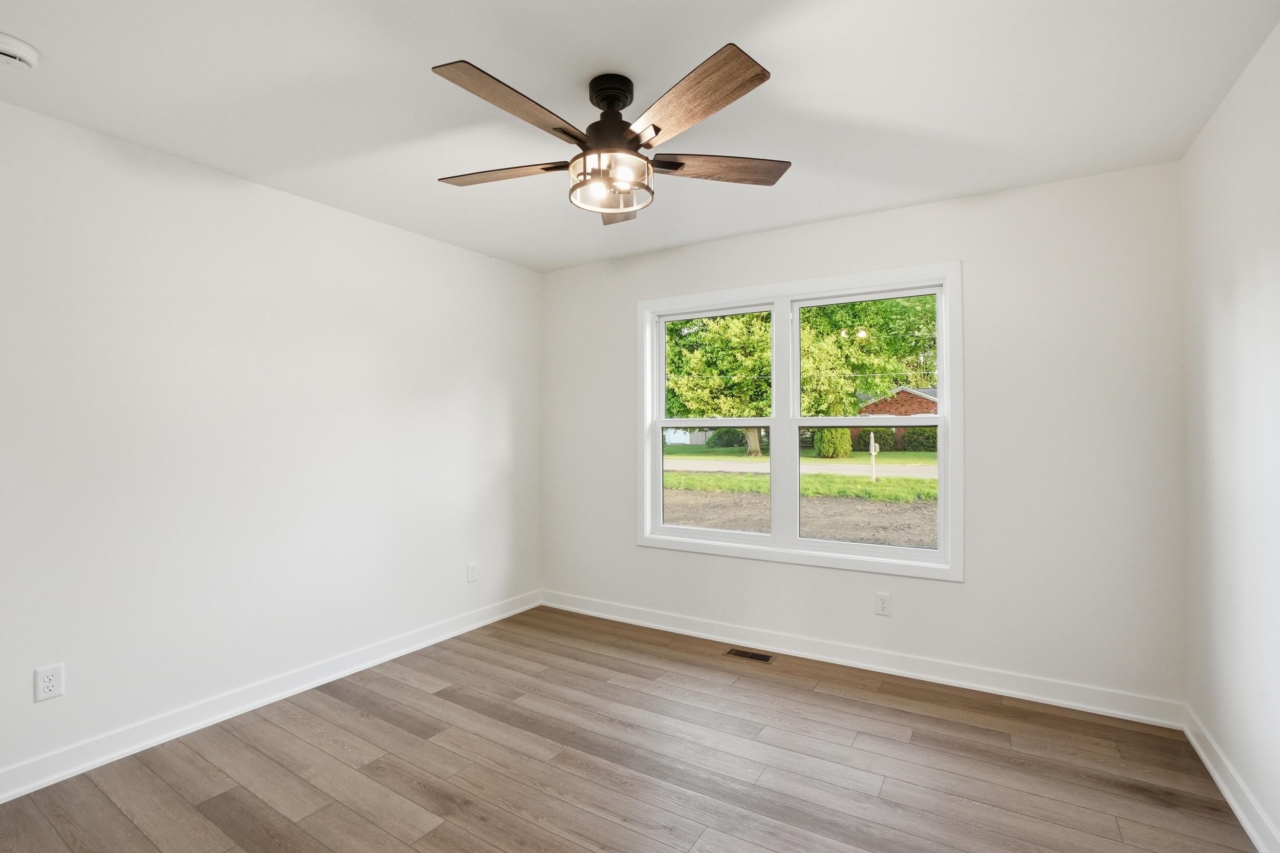 508 West Beaver Street Morocco, IN 47963 - Photo 30 of 33 an empty room with wooden floor fan and windows