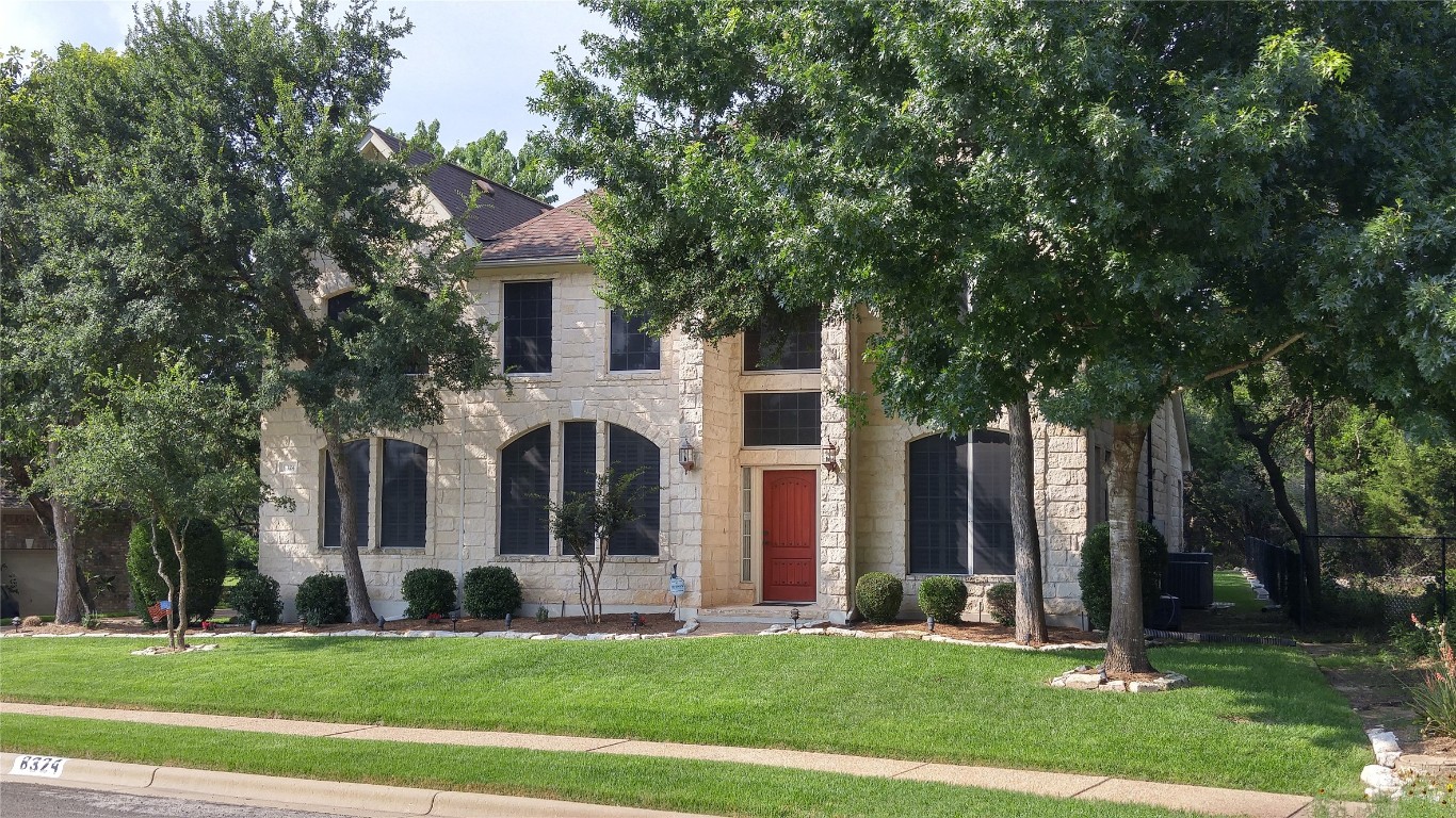 8324 Elander Drive Austin, TX 78730 - Photo 1 of 1 a front view of a house with a garden