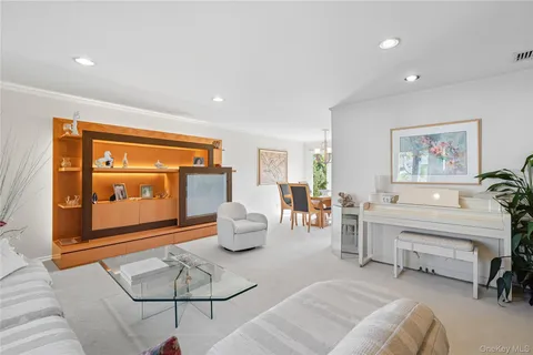 a living room with furniture a rug and white walls