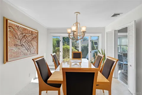 a view of a dining room with furniture wooden floor and chandelier