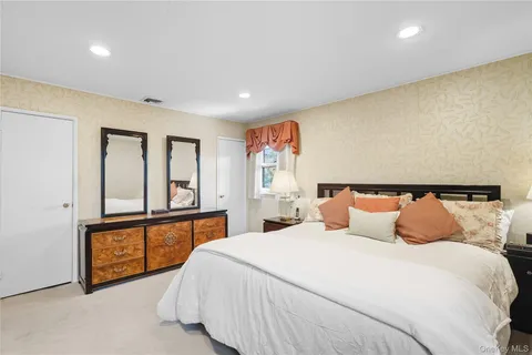 a bedroom with a large bed and a large window