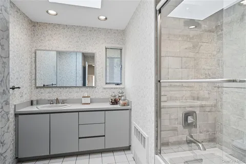 a bathroom with a double vanity sink and a mirror