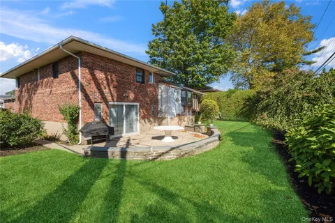 a view of backyard with a table and chairs and potted plants