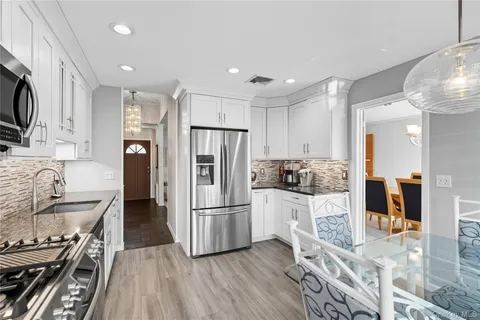 a kitchen with stainless steel appliances a refrigerator sink and stove